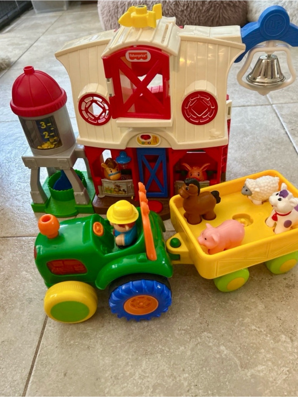 Fisher-Price colorful farm tractor playset with red barn and yellow trailer